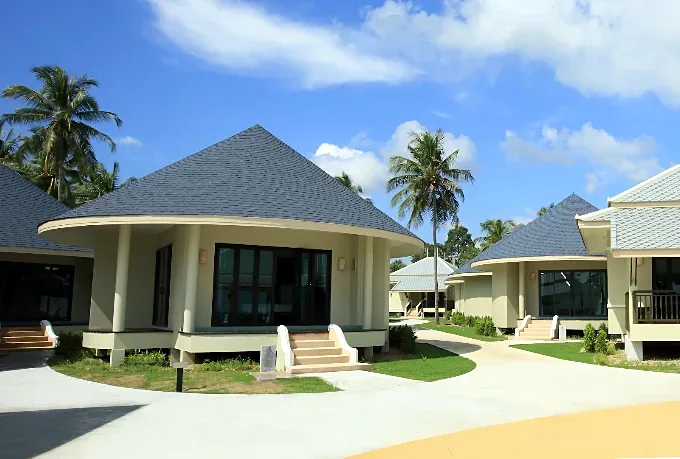 Round Yurt style bungalows among tropical palms