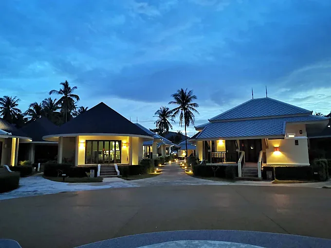 bungalows lit up at dusk